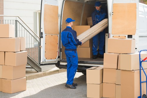 Moving team handling household items during a London home relocation