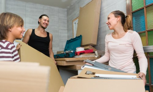 Professional movers loading furniture in a London residential street