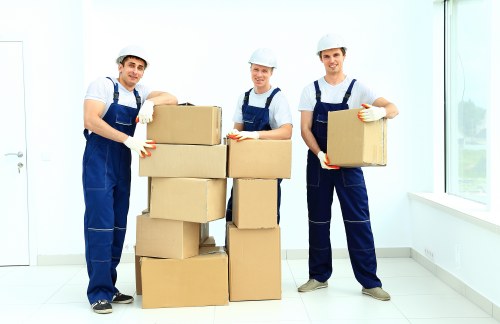 Removalists carrying household items through a London property