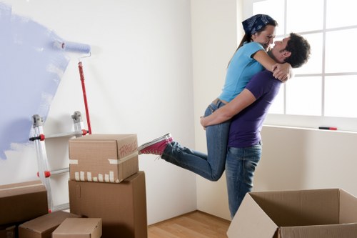 Professional movers carrying items in a London property