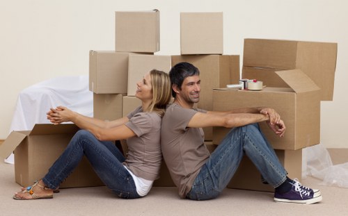 Professional movers carrying items in a London apartment building