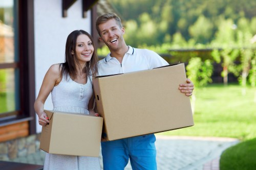 Local house removalists helping with furniture placement at a London home
