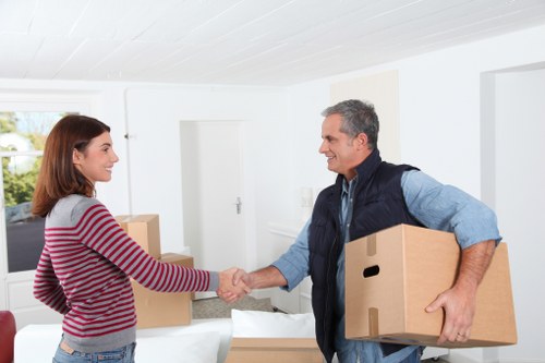 Local movers handling furniture in a London street