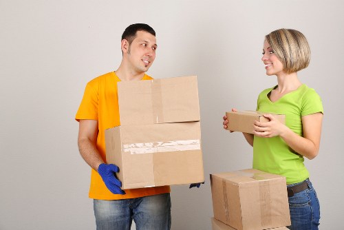 Packed boxes and furniture being loaded into a removal van in London
